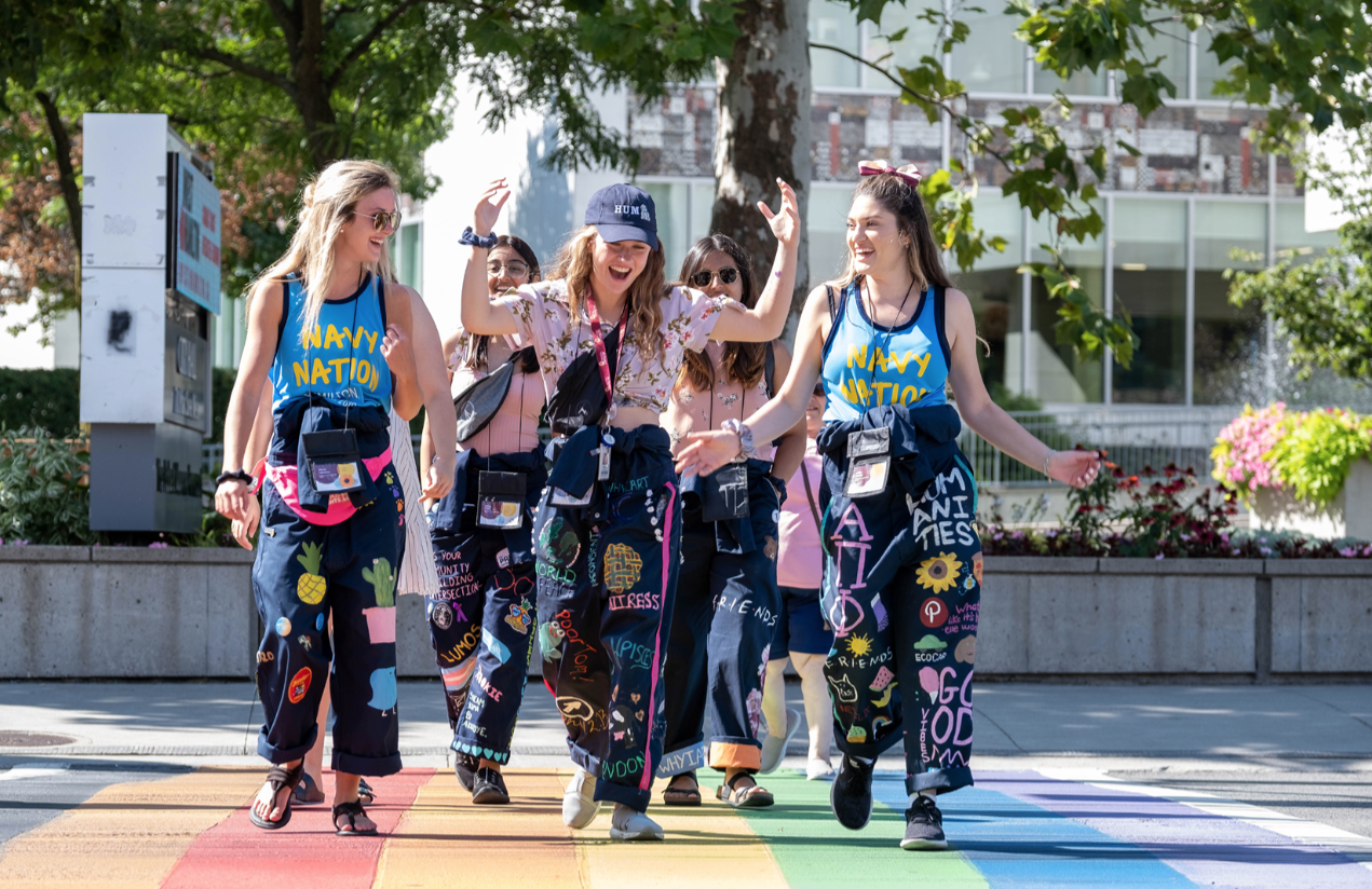 Group or students laughing and walking on campus during frosh week